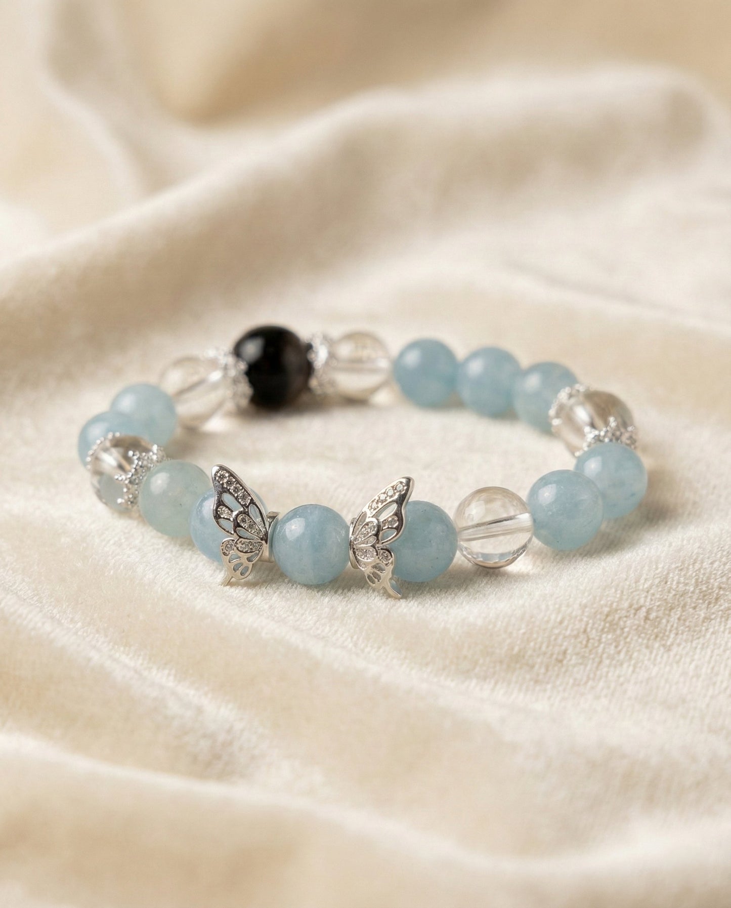 The Azure Whisper Bracelet, shown at a gentle angle on a light velvet surface.