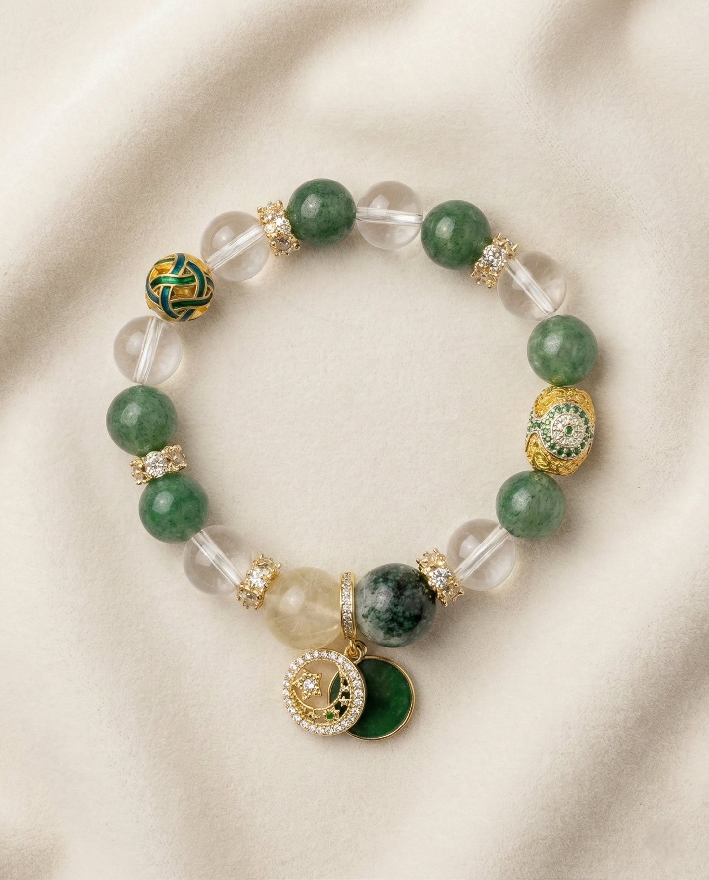 The Abundance Flow Bracelet, photographed from above on a light velvet background.