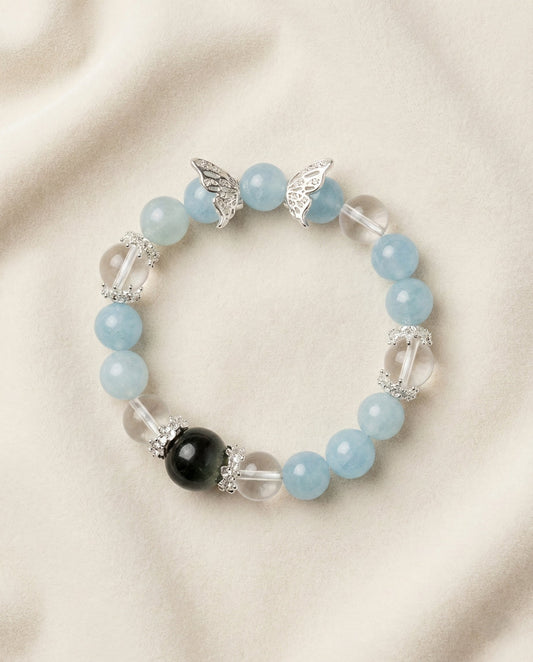 The Azure Whisper Bracelet, photographed from above on a light velvet background.