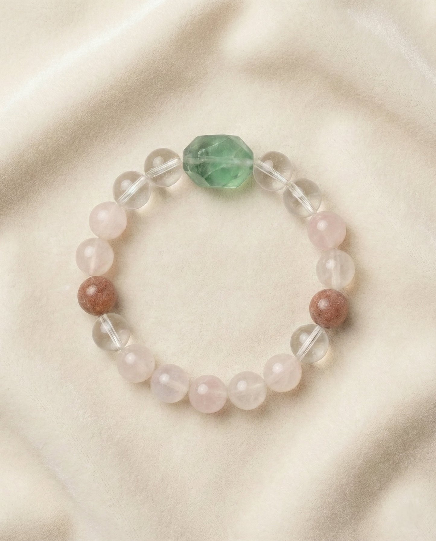 The Blooming Heart Bracelet, photographed from above on a light velvet background.