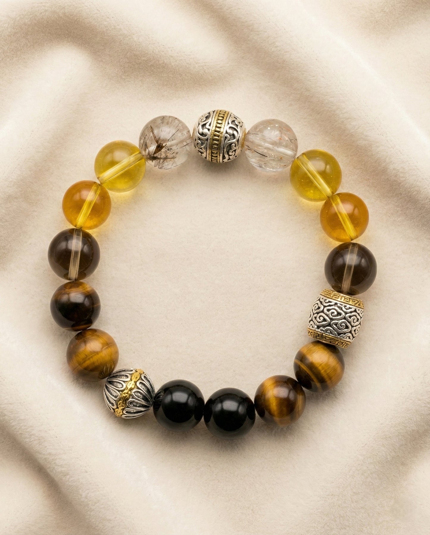 The Gilded Guardian Bracelet, photographed from above on a light velvet background.