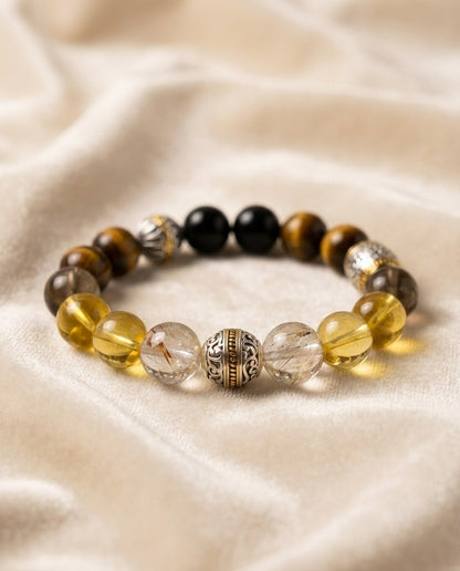 The Gilded Guardian Bracelet, shown at a gentle angle on a light velvet surface.