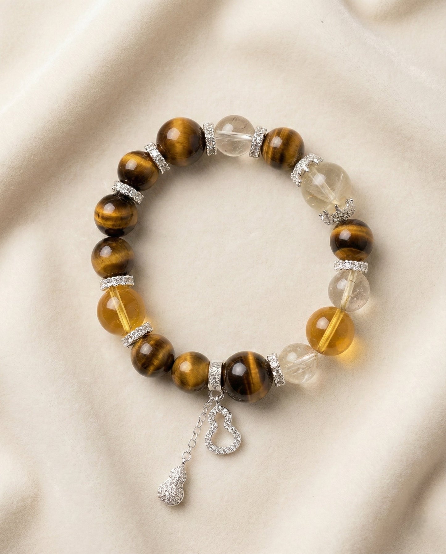 The Golden Ascendant Bracelet, photographed from above on a light velvet background.