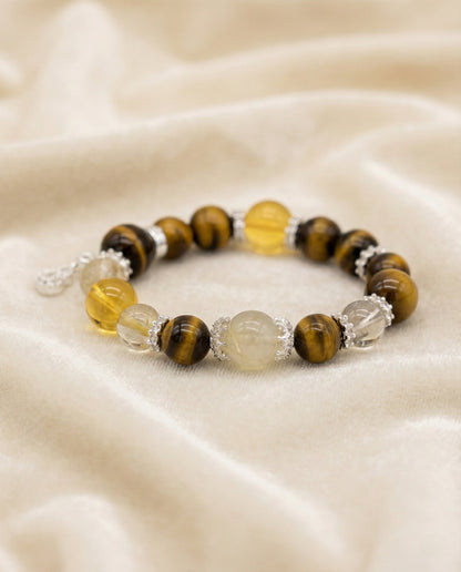 The Golden Ascendant Bracelet, shown at a gentle angle on a light velvet surface.