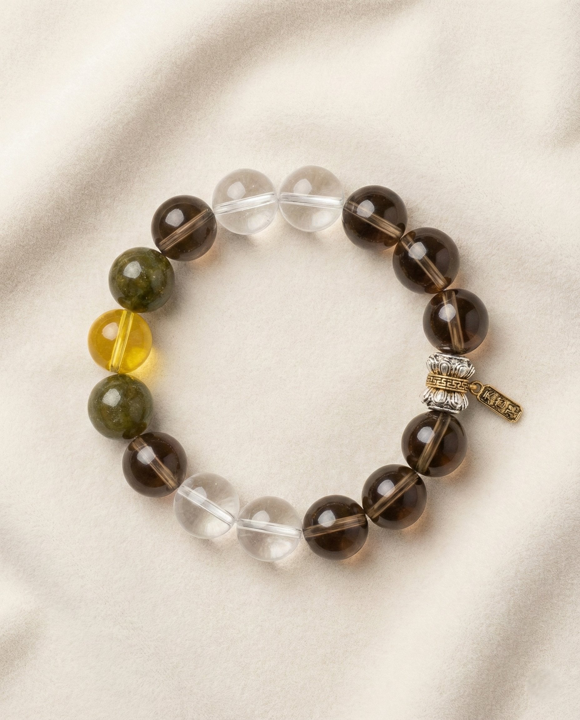 The Grounded Anchor Bracelet, photographed from above on a light velvet background.