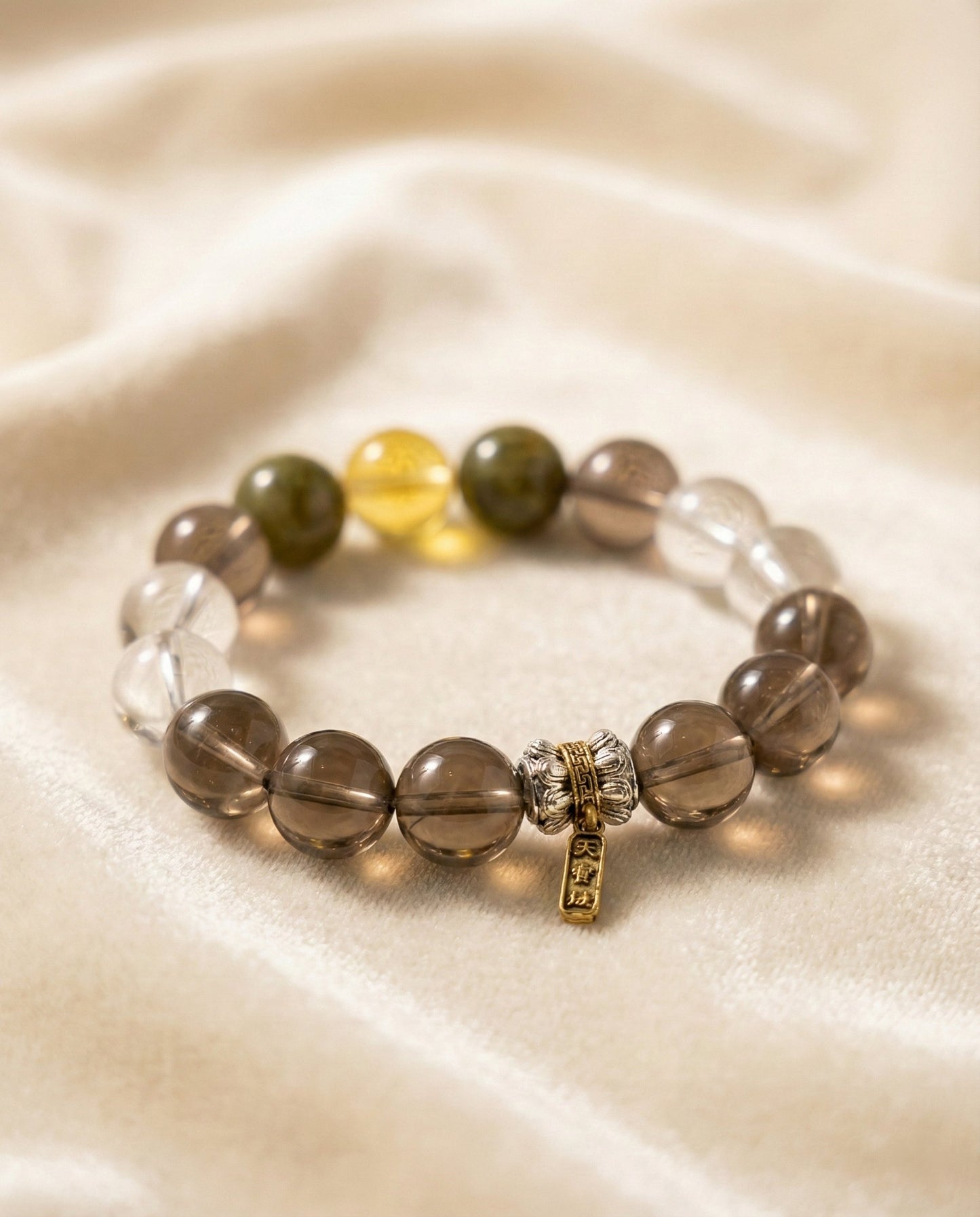 The Grounded Anchor Bracelet, shown at a gentle angle on a light velvet surface.