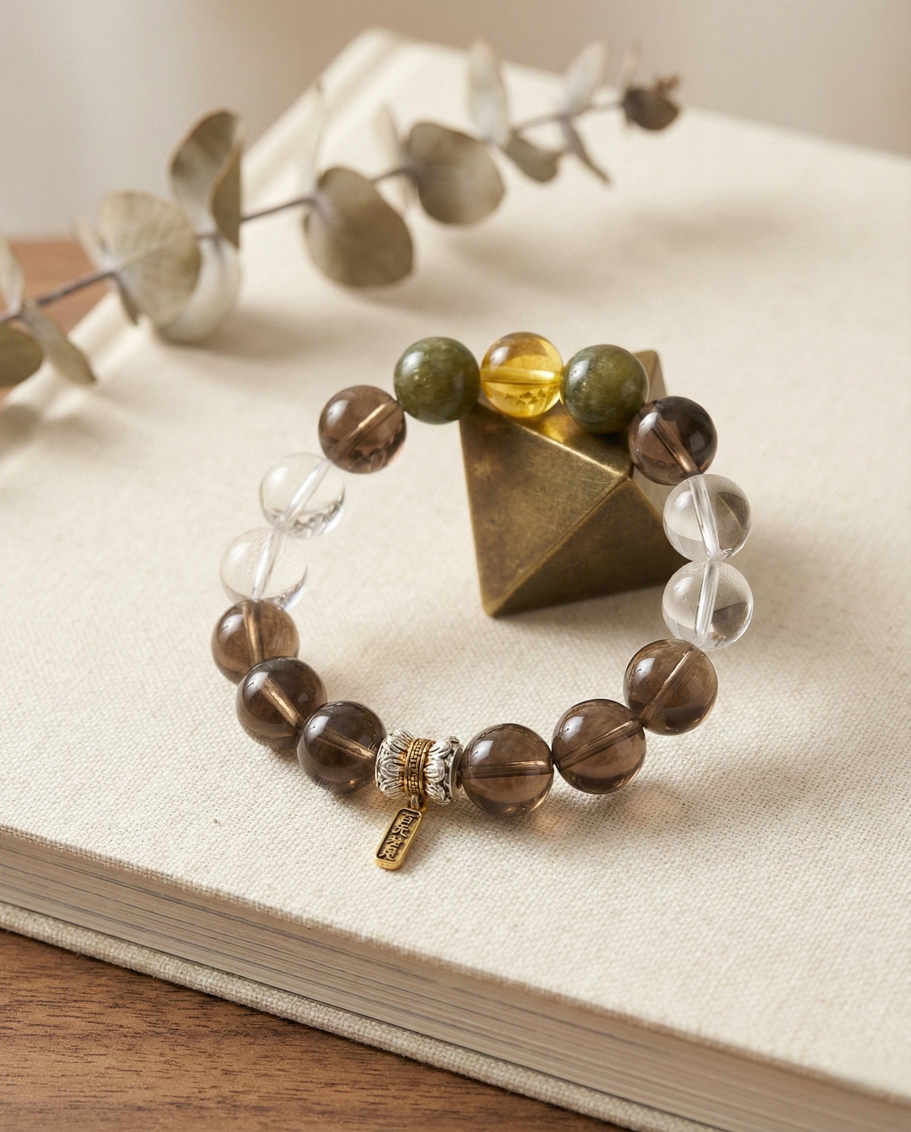 The Grounded Anchor Bracelet styled with symbolic objects in a serene environment — Balance & Protection Series