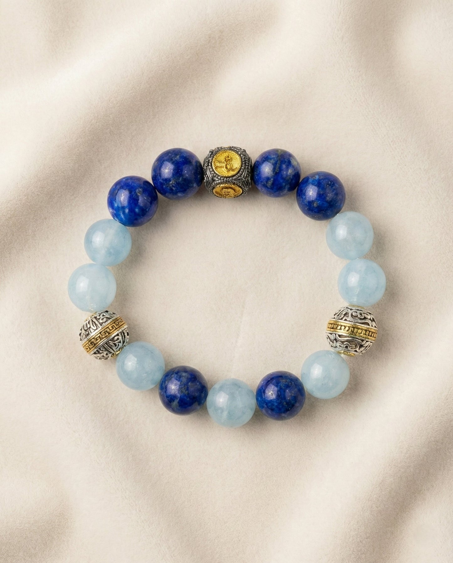 The Meridian Anchor Bracelet, photographed from above on a light velvet background.