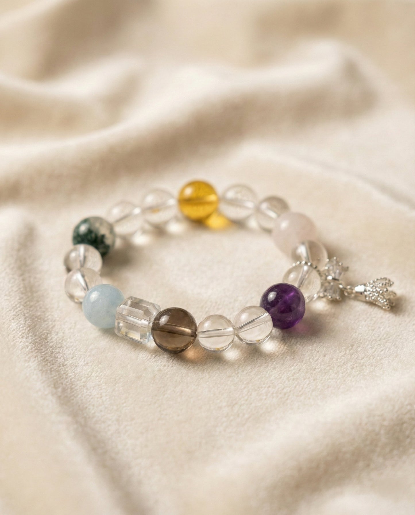 The Prism Harmony Bracelet, shown at a gentle angle on a light velvet surface.