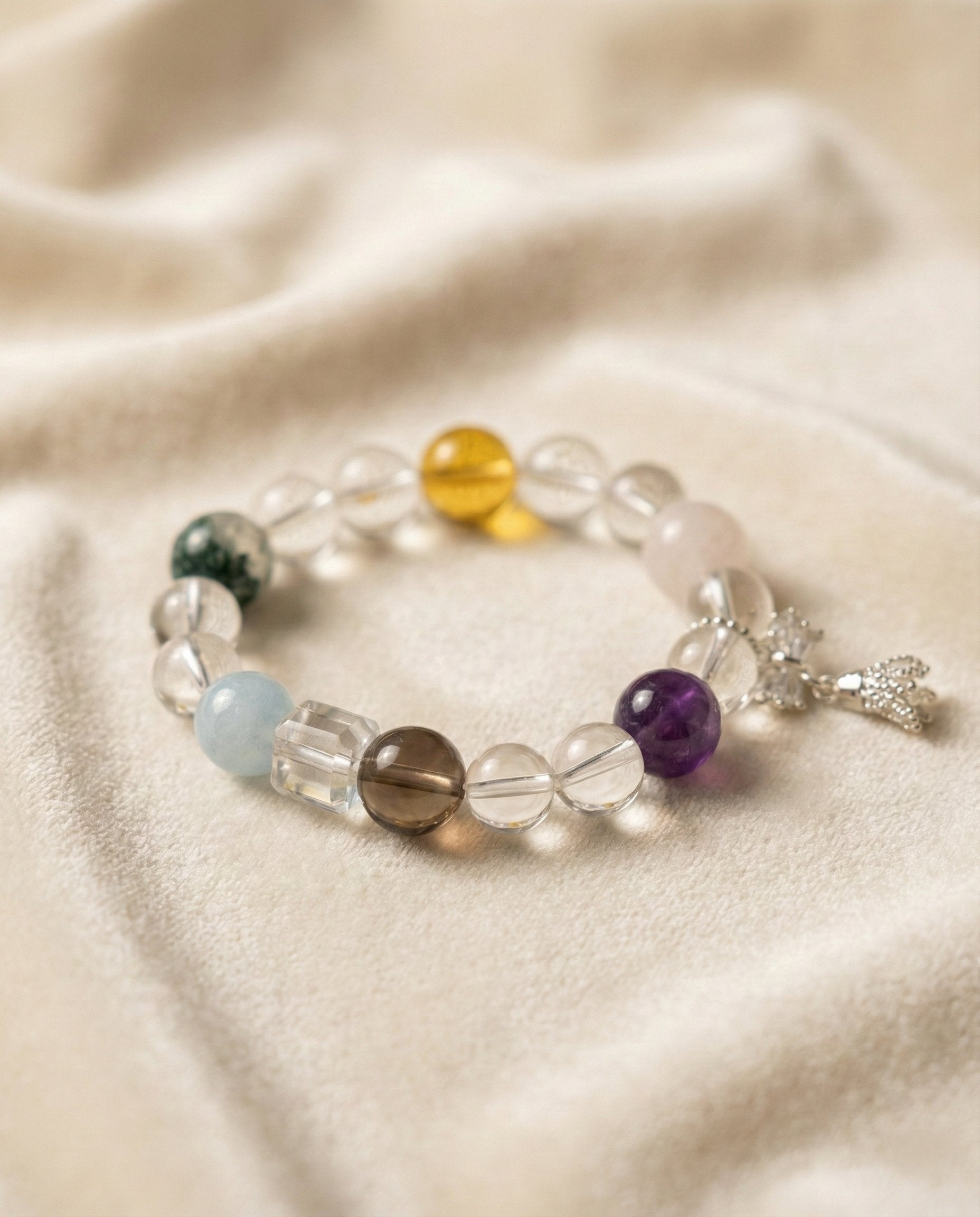The Prism Harmony Bracelet, shown at a gentle angle on a light velvet surface.