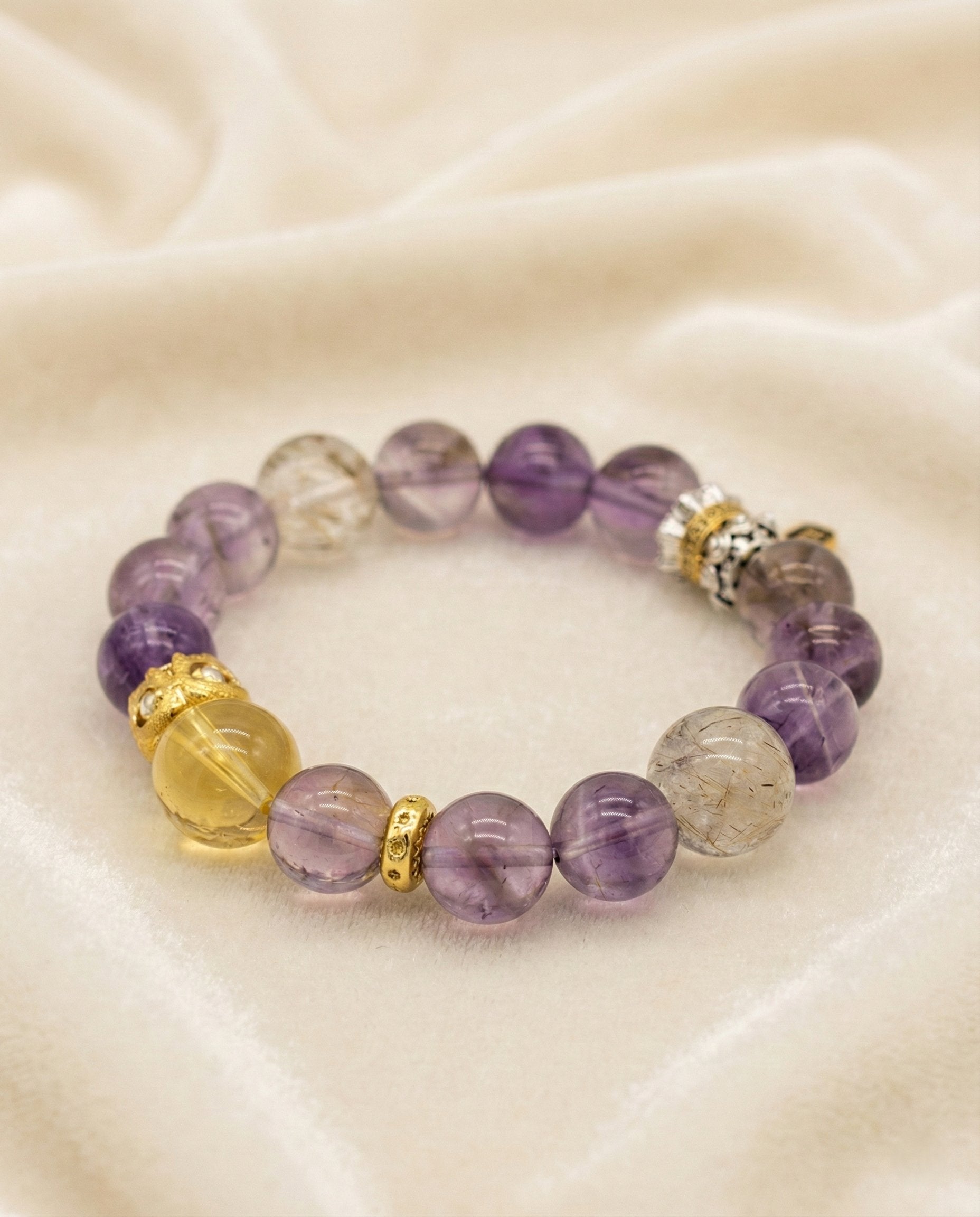 The Purple Sanctuary Bracelet, shown at a gentle angle on a light velvet surface.