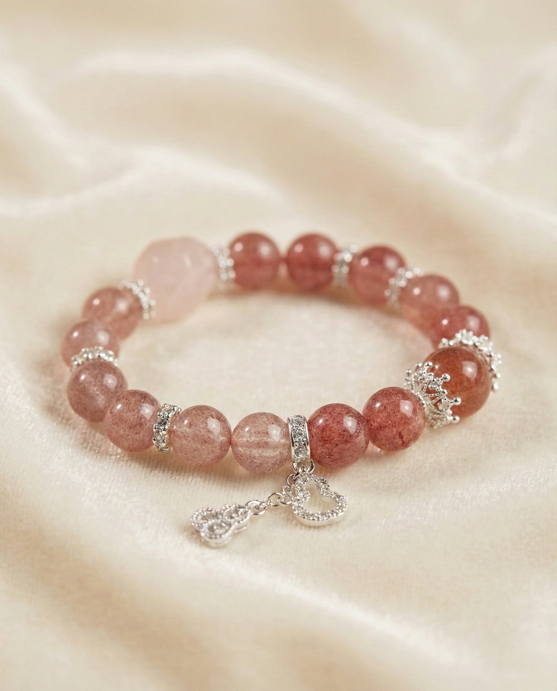 The Sweet Embrace Bracelet, shown at a gentle angle on a light velvet surface.