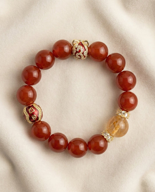 The Vermilion Fortune Bracelet, photographed from above on a light velvet background.